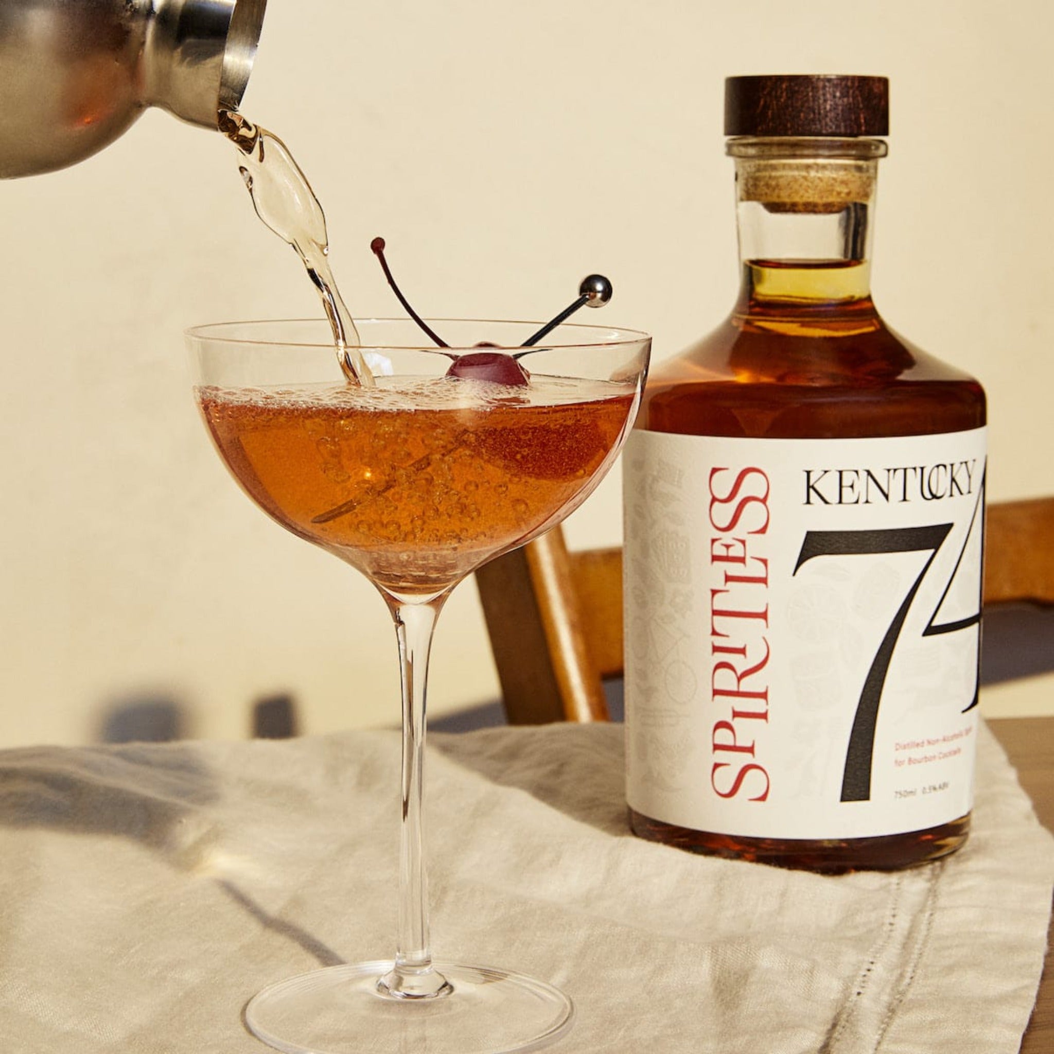 Spiritless Kentucky 74 Non-Alcoholic Bourbon with glass